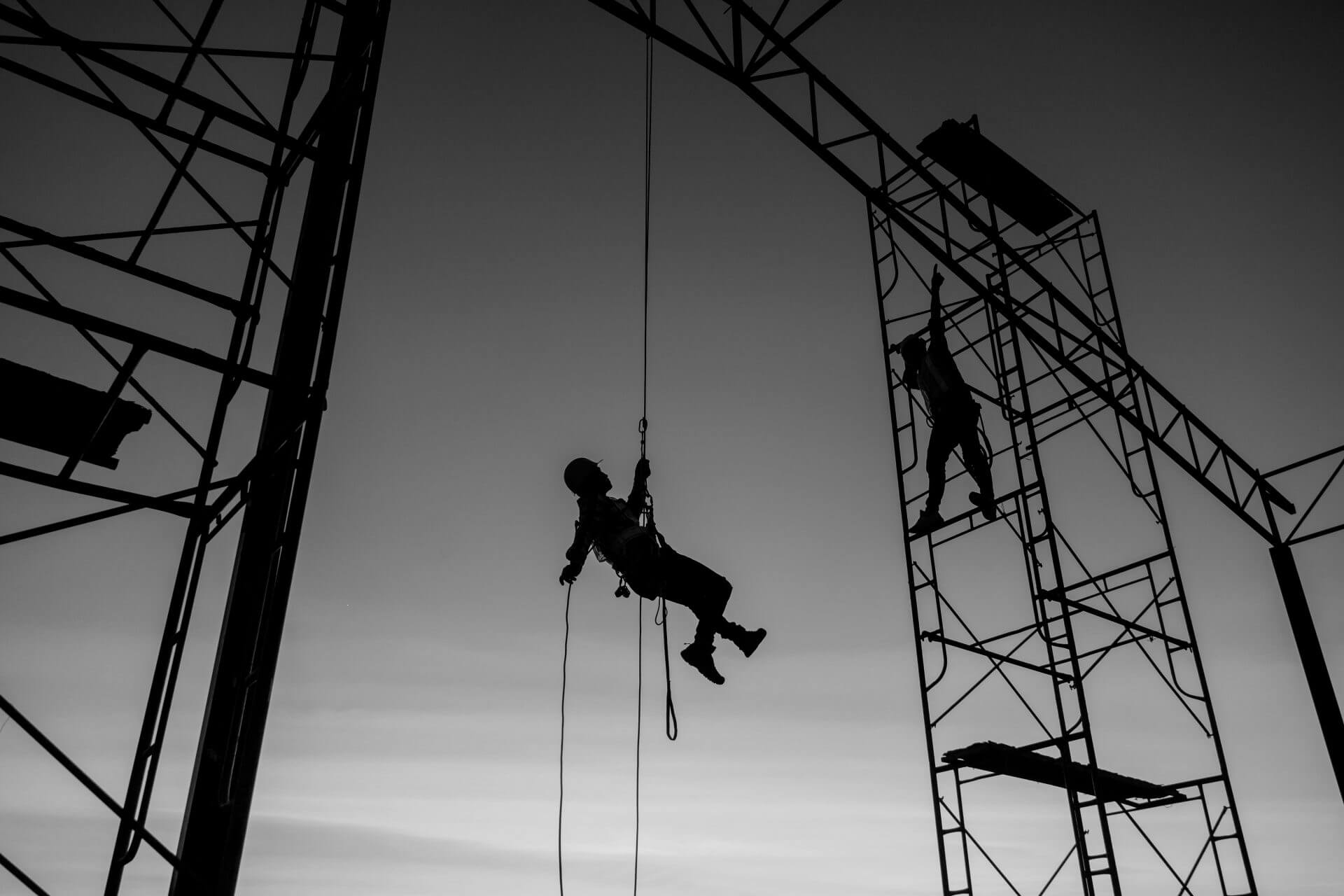 Male working abseiling on a construction site silhouette workerloading=